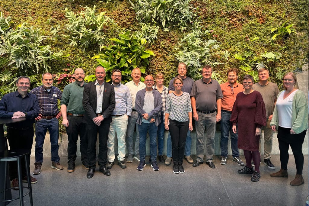 persons in front of green wall