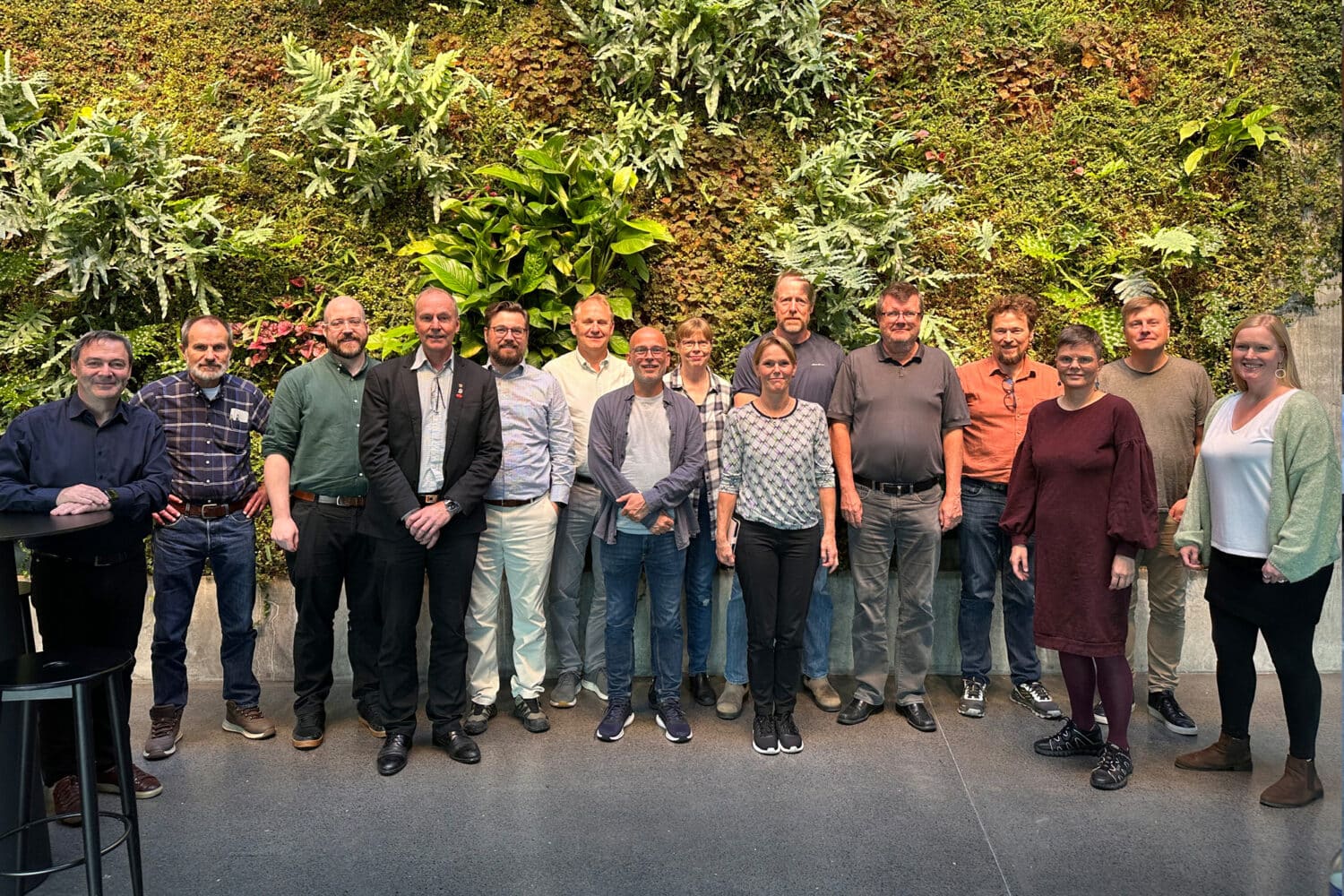 persons in front of green wall